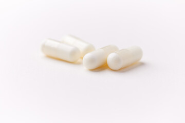 Creatine capsules on paper background. Soft focus. Close up. Copy space.	