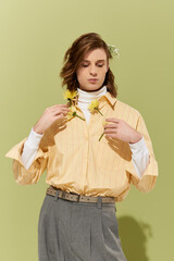 Fashionable young man expressing style with flowers against a vibrant background