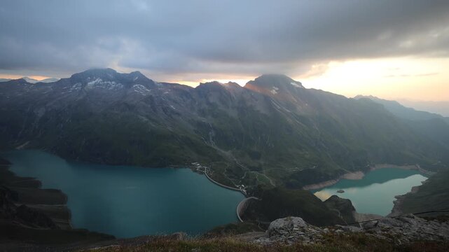 Alps mountains beautiful landscape. Austrian Alps in Salzburg region hiking trail scenic video timelapse of clouds moving above two mountain lakes with turquoise water Mooserboden Staudamm in Austria