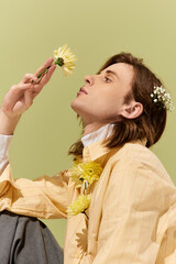Captivating portrait of a young man expressing style with floral accents in a vibrant setting