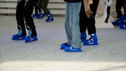 People ride on the skating rink on the ice rink during the Christmas holidays. Sports and fun pastime.