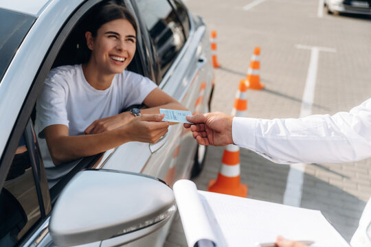 Congratulations giving the license, passed. Woman is trying to pass exam in the driving school