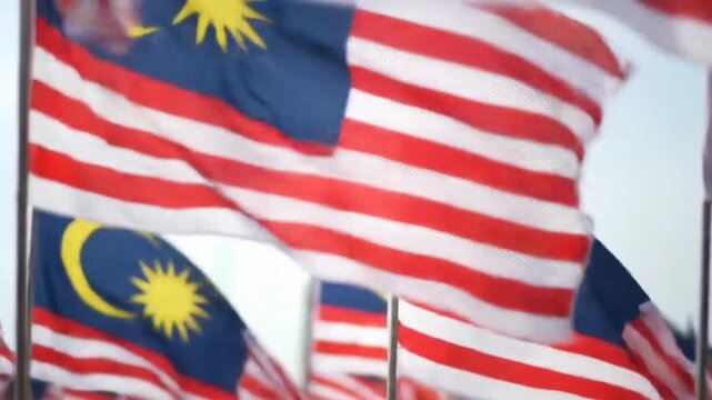 A sea of Malaysian flags, the Jalur Gemilang, waving proudly in the wind on a bright, celebratory national day