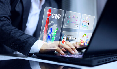 Global warming potential GWP concept with businessman working on laptop computer to compare value...