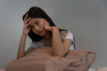 asian woman in bed late trying to sleep suffering insomnia, sleepless or scared in a nightmare,...