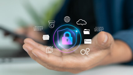 Hand holding hologram lock and technology icons representing cybersecurity, data privacy, cloud storage, and secure digital systems for business.