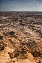 Fototapeta premium Vertical view of desert mountains and rugged terrain near Moçâmedes, Angola
