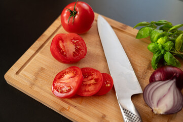 tomatoes and knife on cutting board