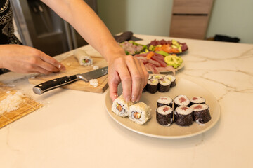 Homemade Sushi with sashimi and Fresh Ingredients on a Marble Countertop