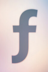 Obraz premium Soft and elegant lowercase f silhouette against blurred pastel backdrop, clean professional design, visual focus on shape