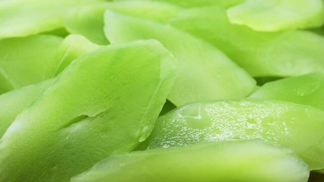 closeup green slice cut wosun or celtuce stem lettuce food rotate rotation food video footage background