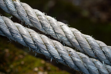 close-up view of two thick, weathered ropes, showing their intricate twists and texture in detail...