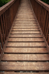 Wooden pedestrian bridge with strong perspective and symmetry