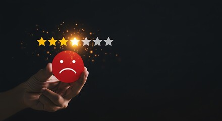 Hand holding red unhappy face with mixed review rating stars on dark background