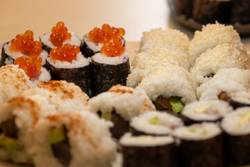Close Up of Homemade Sushi Rolls Topped With Fresh Caviar and Varied Fillings