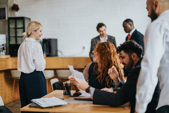 Group of businesspeople discussing documents and ideas in a cozy cafe co working space, fostering teamwork and creativity. - Powered by Adobe