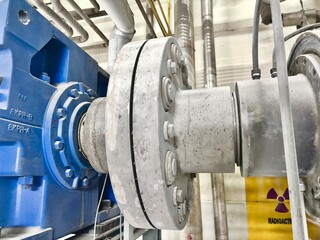 High-pressure industrial pump coupling in a specialized manufacturing facility, featuring...