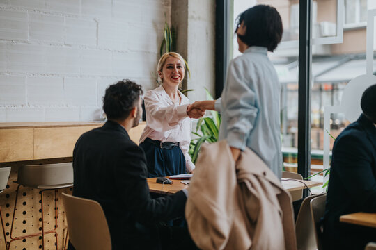 Professional colleagues engage in a discussion at a stylish co working space, fostering collaboration and networking. A scene of teamwork and communication in a dynamic, modern environment.