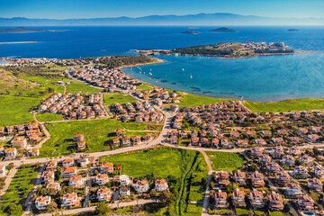 Scenic aerial view of the beautiful coastal town of Ayvalik in Balikesir, Turkey, featuring charming houses, turquoise waters, and idyllic islands