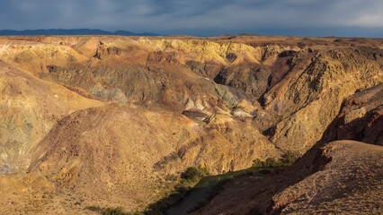 Rust-hued mountain canyon in Kazakhstan, showcasing nature's artistic geological formations.