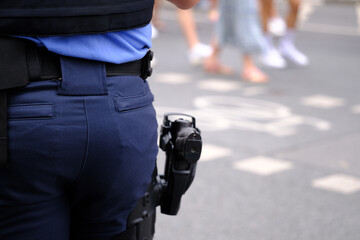 German police officer, policeman backside, gun in holster, uniformed policeman patrolling streets,...