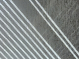 Diagonal Sunlight Shadows on Gray Wooden Wall