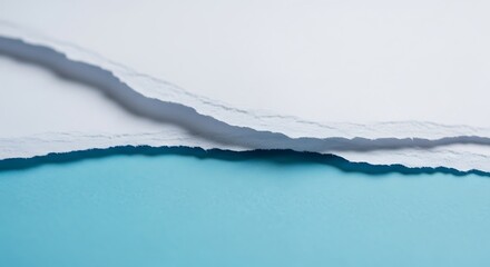 A torn piece of white paper reveals a vibrant blue background underneath