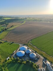 Aerial view large biogas power plant with silos and tanks for renewable energy production.