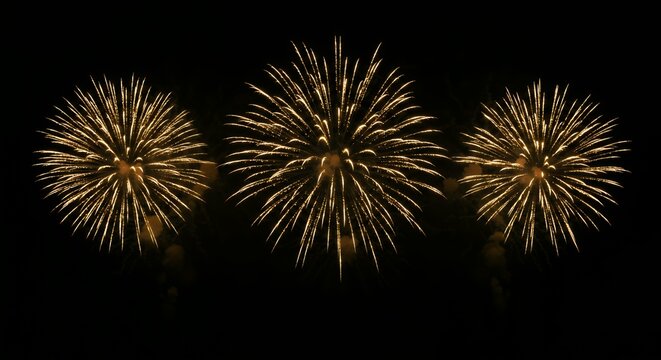 Three golden fireworks bursting simultaneously in dark night sky creating synchronized celebration display with radial spark patterns