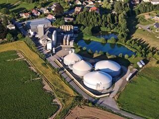 Aerial view large biogas power plant with silos and tanks for renewable energy production.	
