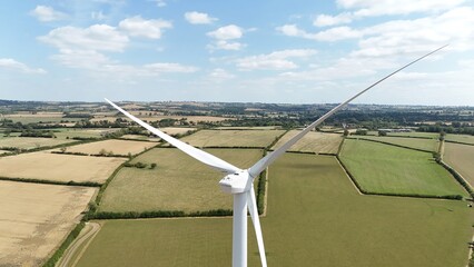Aerial drone view of wind turbine power plants renewable energy electricity with rural English...