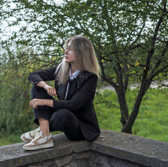 Young rebellious student in white shirt, black tie and school blazer, urban Millennials style....