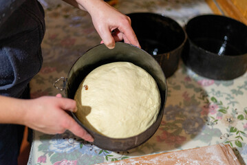 Woman preparing homemade bread dough in rustic kitchen