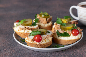 Bruschetta with baked chicken, processed cheese and cherry tomatoes on gray plate