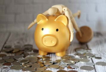Wooden mannequin hugging a piggy bank save keep money photo