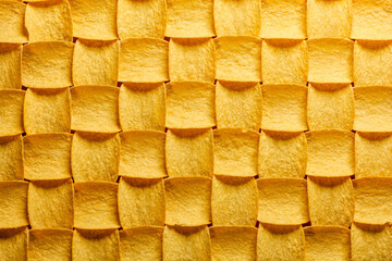 Yellow potato chips pattern with light from top right
