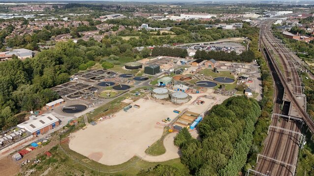 Aerial drone view of wastewater treatment plant, filtration ponds and settling pools, removing sewage to drinking water in Rugby England UK Europe WFD