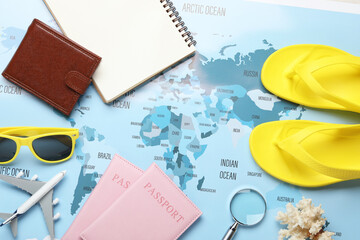 Time for summer vacation. Toy plane, passports, purse, magnifying glass, notebook and beach...