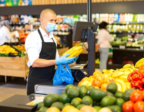 Man in a mask and gloves weighing bananas at a grocery store