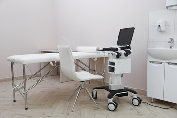 Modern ultrasound machine and examination bed in clinic