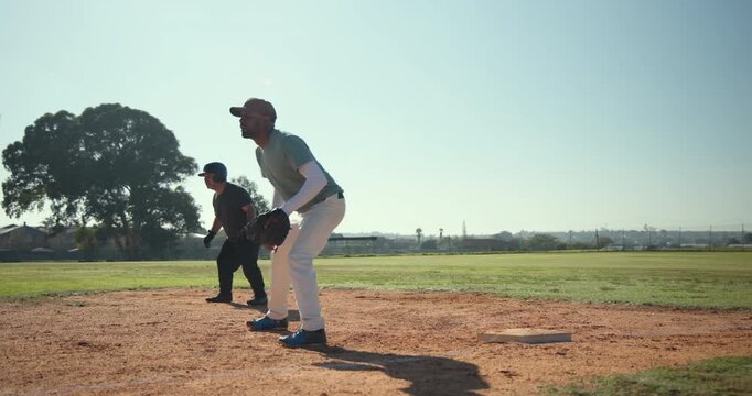 White male first baseman catching pickoff and tagging Hispanic runner sliding back to base infield
