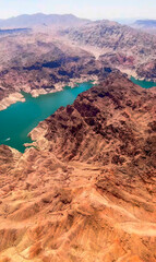Crimson-hued canyons embrace emerald waters in a kaleidoscope of contrast, echoing Earth Day's...