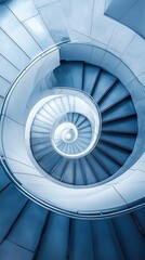 Fototapeta premium An aerial shot of a spiral staircase in a modern building, looking straight down to create a hypnotic geometric pattern.