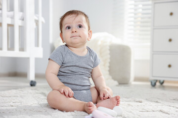 Fototapeta premium Cute little baby on floor in room. Space for text