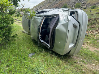 A toppled silver chariot whispers tales of unexpected adventure under rolling hills, embracing...