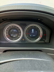 Car dashboard illuminates fuel gauge's enigmatic odyssey, evoking Dia de los Muertos' spirit of journeys and unknown roads