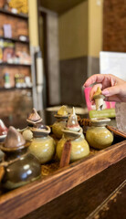 Ethereal scents waft as a hand selects mystical incense, evoking Diwali magic and the ceramic...