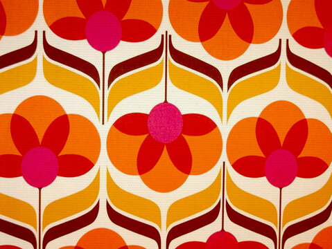 A repeating pattern of stylized flowers in shades of orange, yellow, and pink against a cream background. The design has a retro, 1960s or 70s feel.