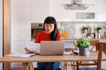 Woman working from home doing paperwork