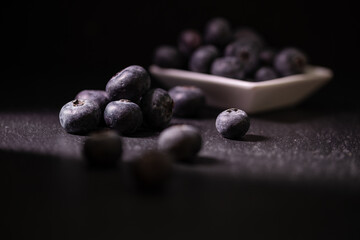 blueberries on the table with dark background